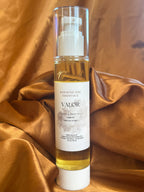 Bottle of Valor beard and body oil on a brown fabric background